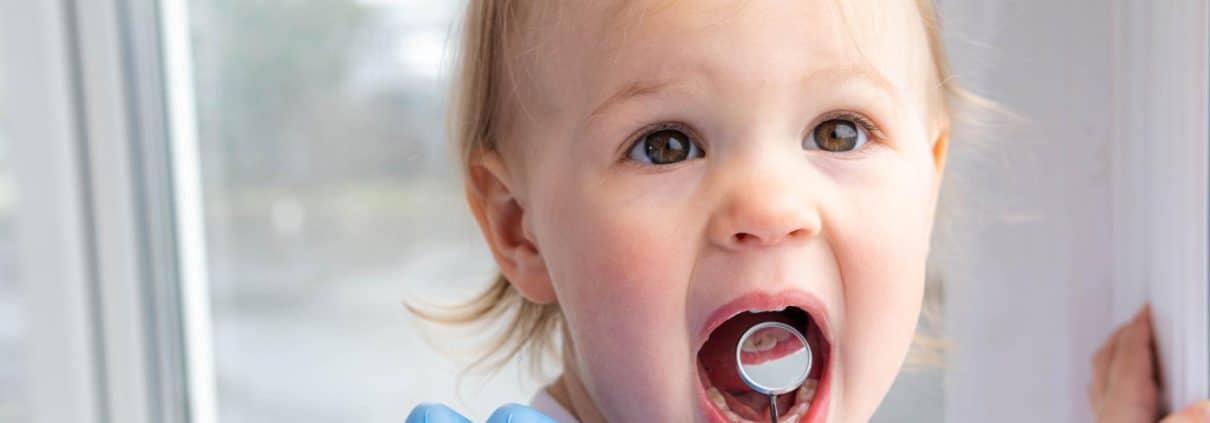 closeup-open-mouth-child-mirror-dentists-hands-blue-gloves-checkup-examine-treating-teeth-child-health-care-children-dental-hygiene